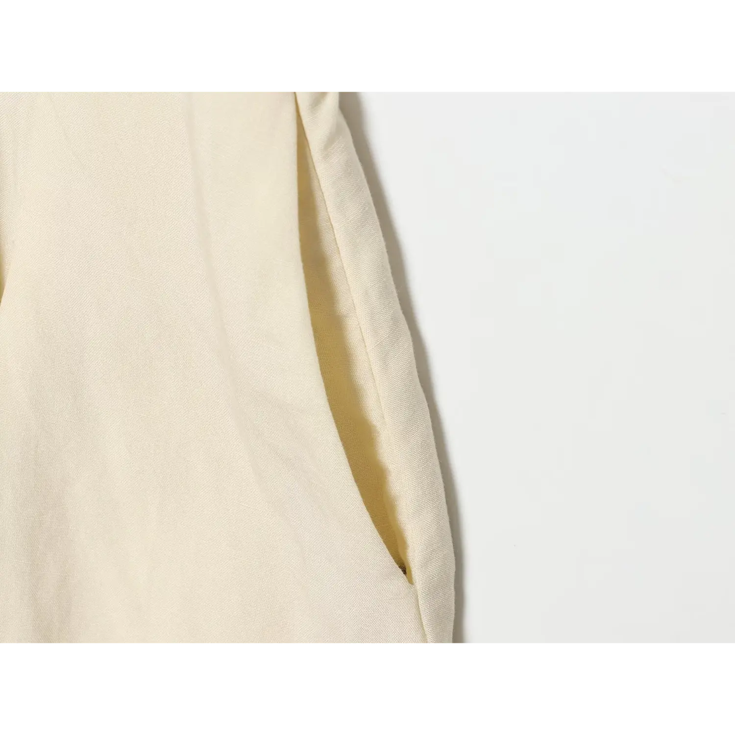 Close‑up side seam pocket on cream linen blend maxi dress