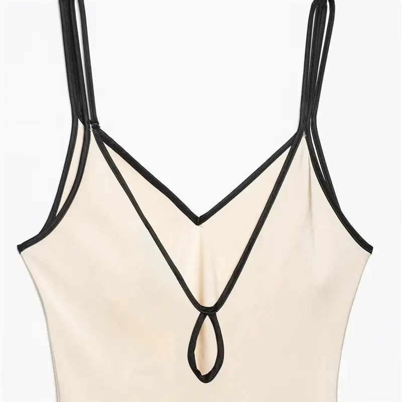Closeup front V neck with teardrop hollow keyhole, full black piping wraps neckline and cutout edge, double adjustable thin straps, wrinkle-free glossy satin
