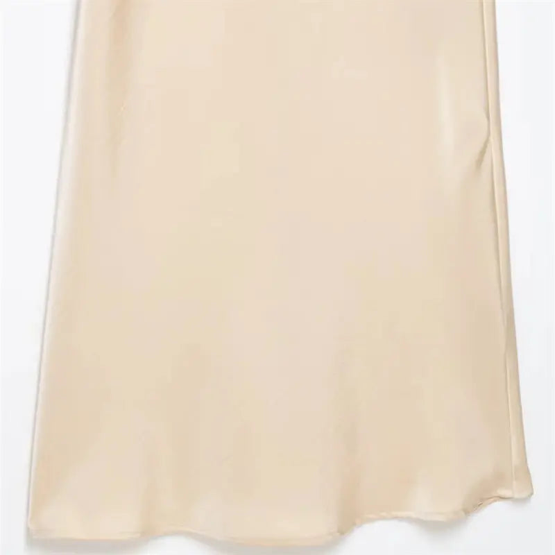 Skirt lower hem fabric macro shot, natural flowing ripple drape texture, subtle pearlescent cream satin luster