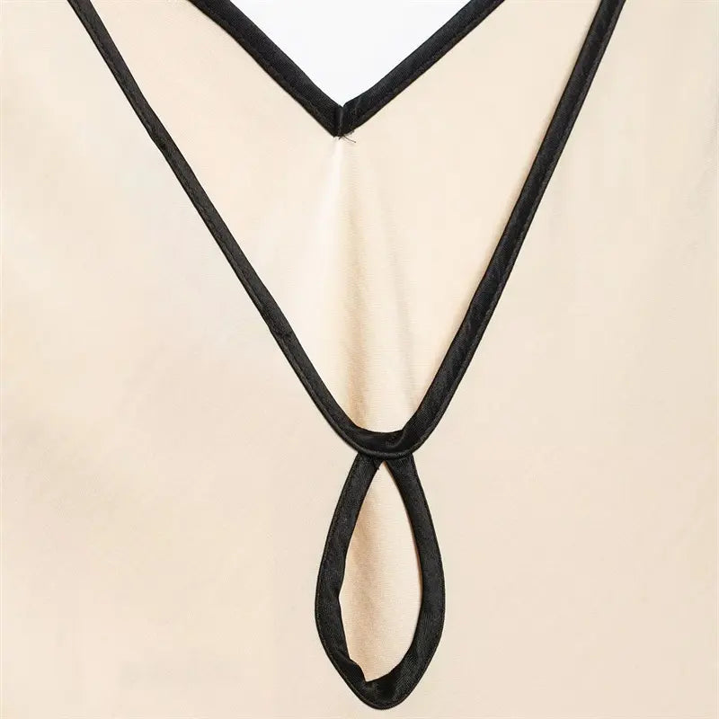 Macro shot teardrop hollow cutout edge, uniform black piping wrapping, neat folded stitching workmanship, thin translucent cream satin fabric