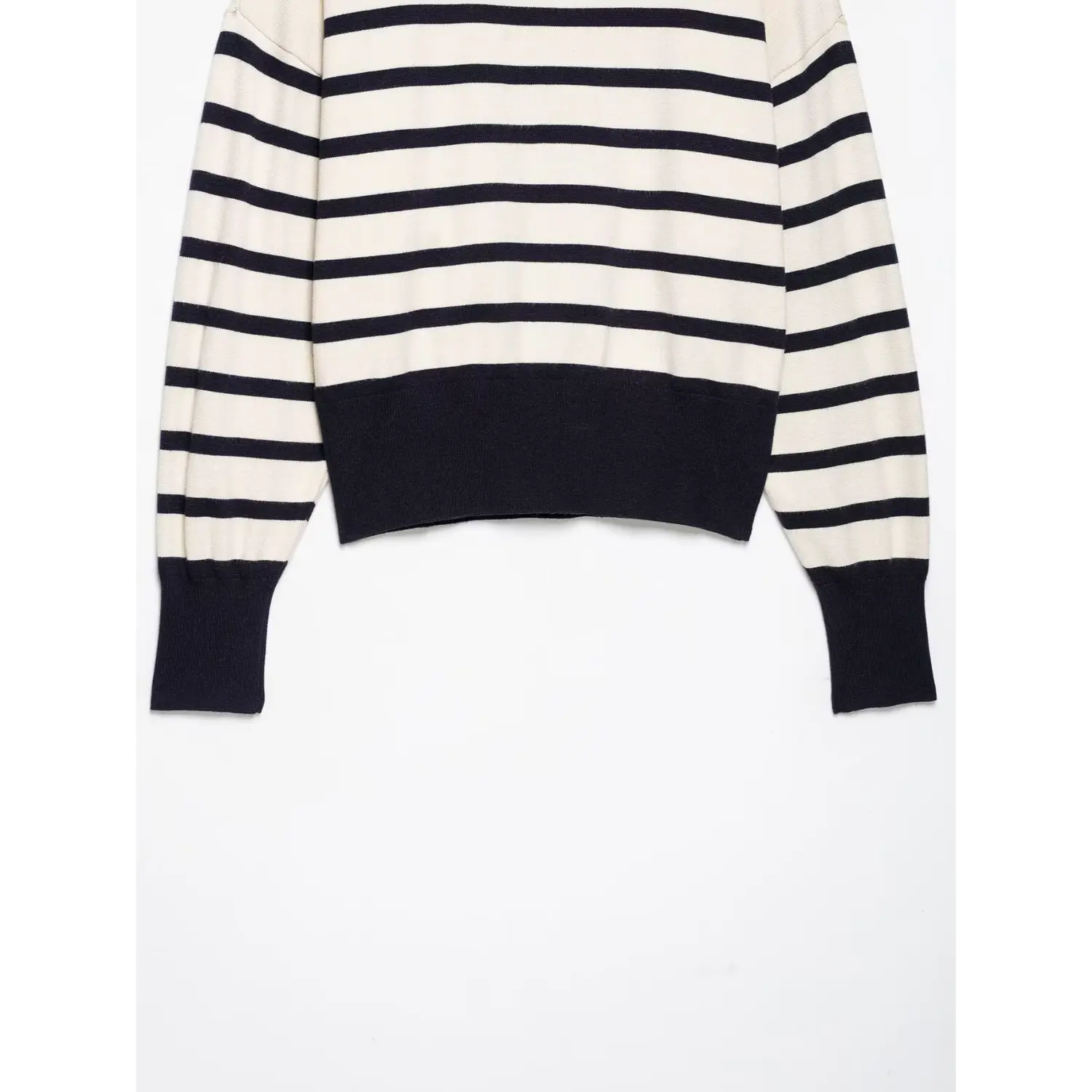 Partial flat‑lay view of cream navy striped knit sweater, showing long sleeves and navy ribbed cropped hem