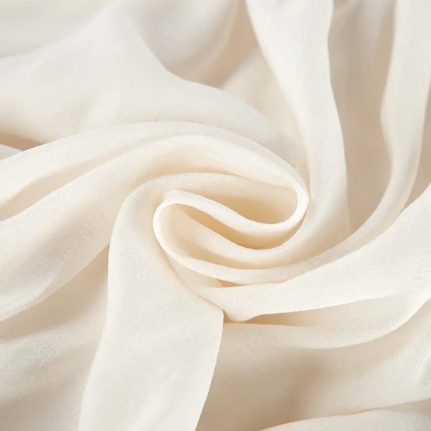 Macro close-up of cream crinkled chiffon fabric
