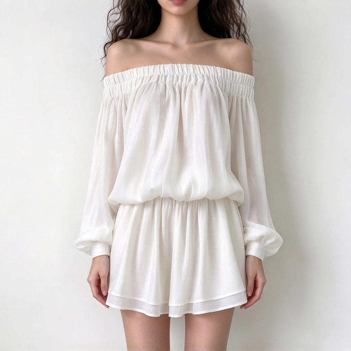Model wearing cream off shoulder smock waist chiffon mini dress, front view
