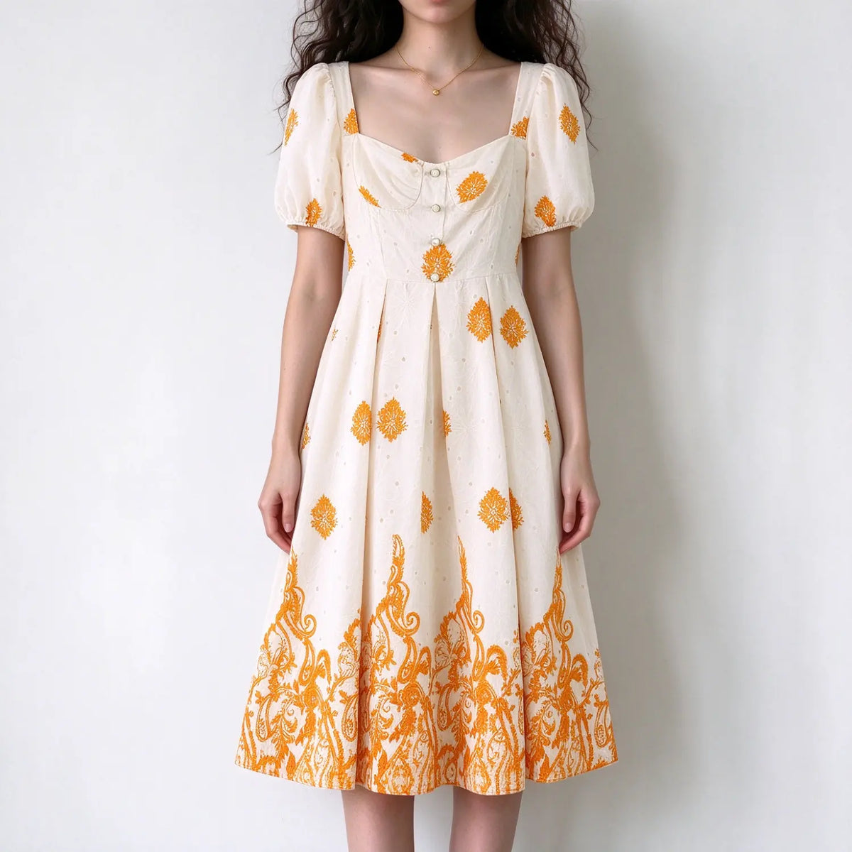Model wearing cream orange floral square neck puff sleeve maxi dress with button front and full skirt, white background