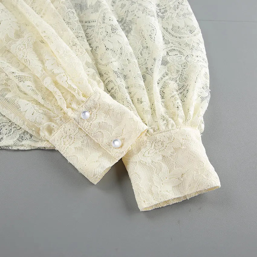 Close-up of lace cuffs with pearl buttons