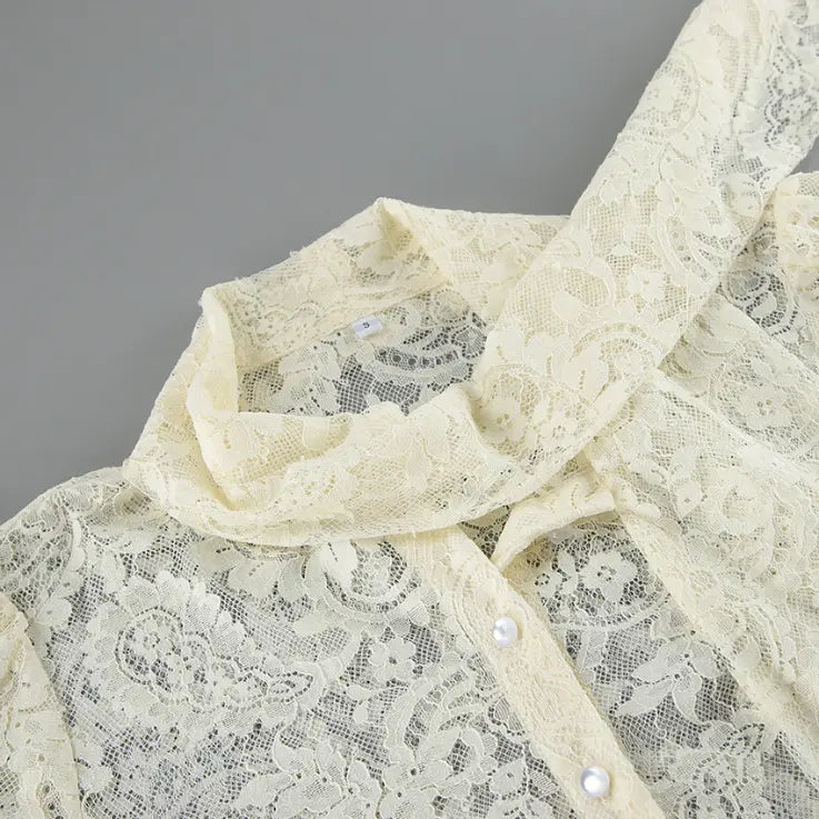 Close-up of high neck and long lace tie