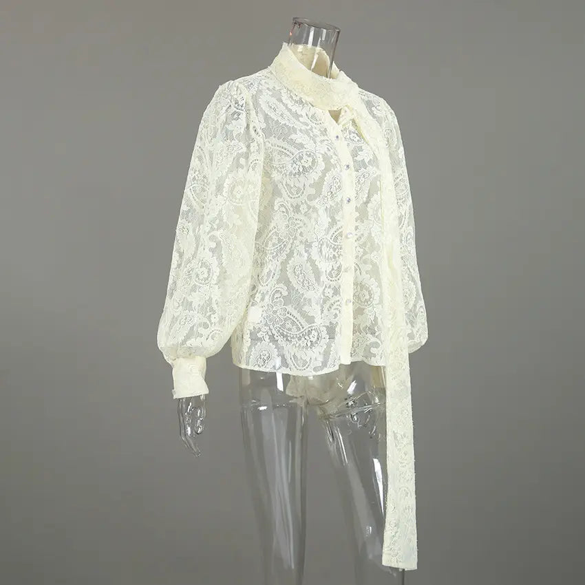 Cream paisley lace pussy bow button blouse on mannequin, three quarter view