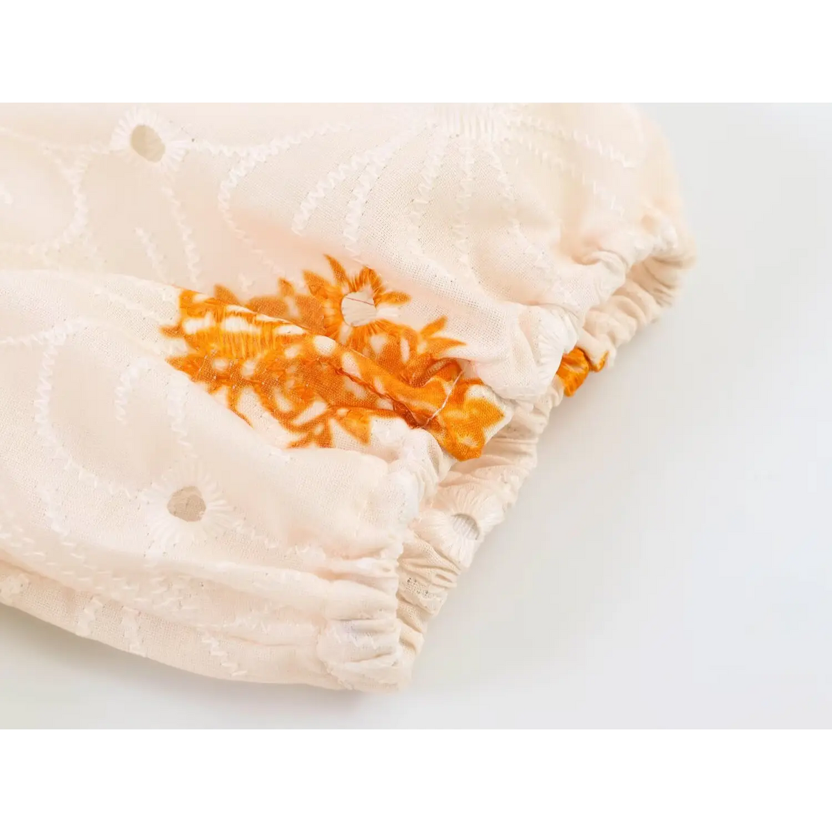Model styling shot of cream orange paisley eyelet maxi dress, casual boho long dress look