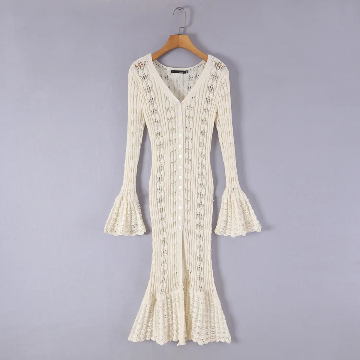 Hanging front view of cream pointelle knit bell sleeve mermaid midi dress