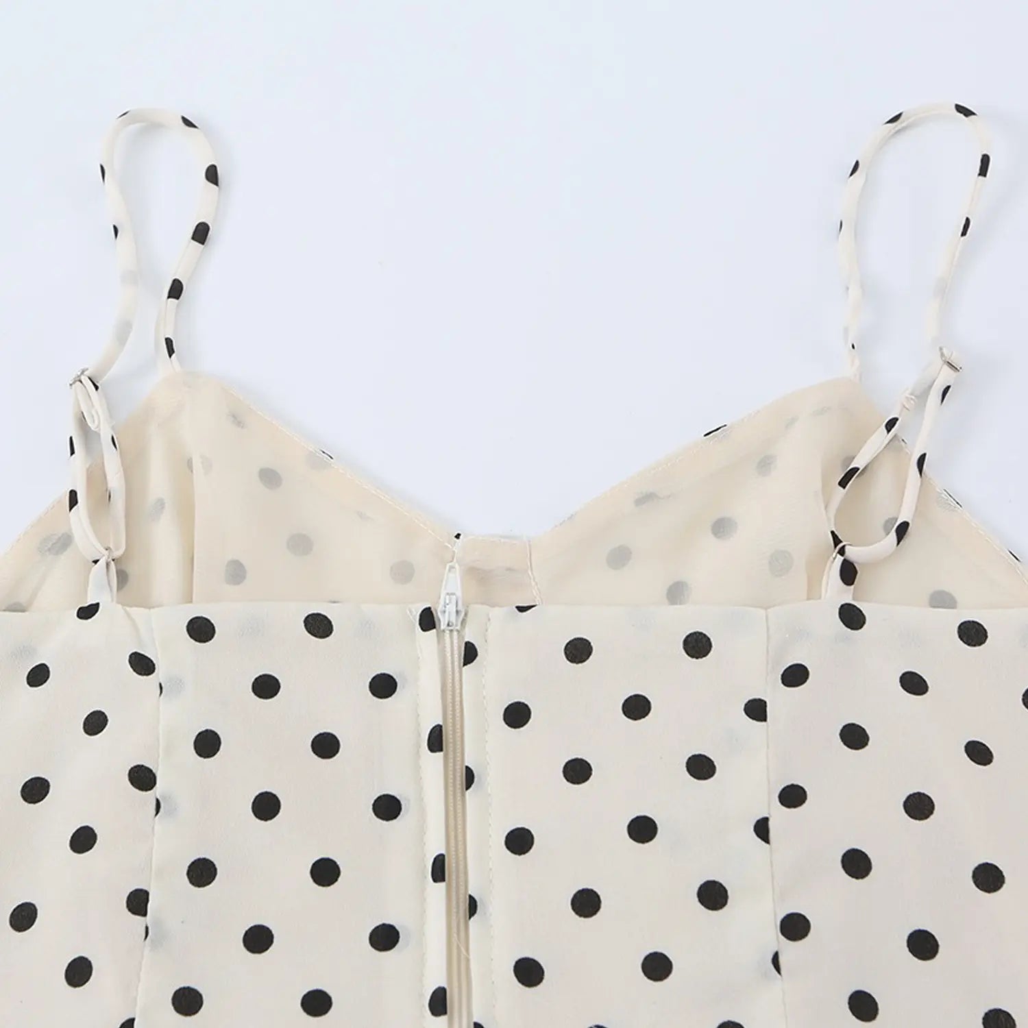 Cream black polka dot cami top back flat lay detail, adjustable dot print thin straps center invisible zipper matching lining white background shot