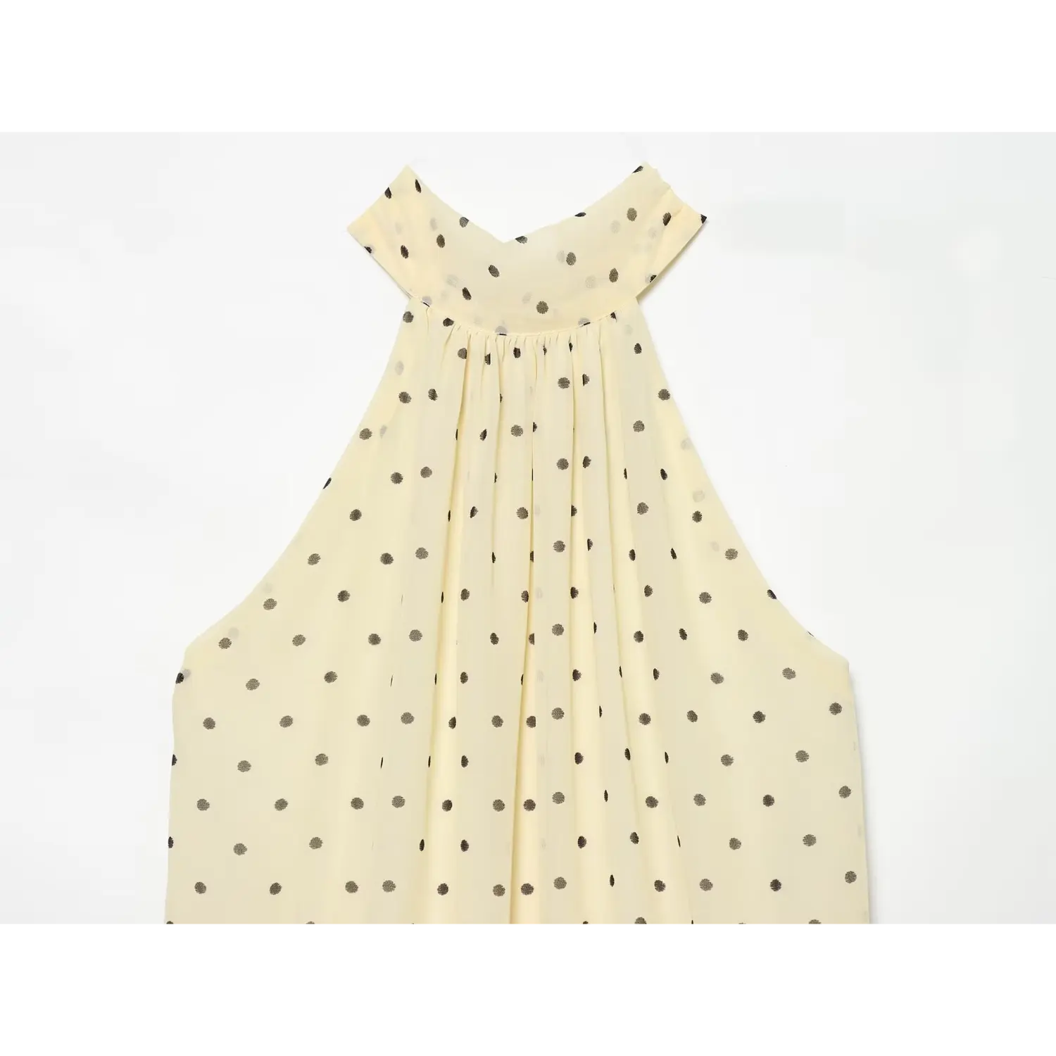 Front close-up of ruched halter neckline, soft chiffon fabric with evenly distributed polka dot print