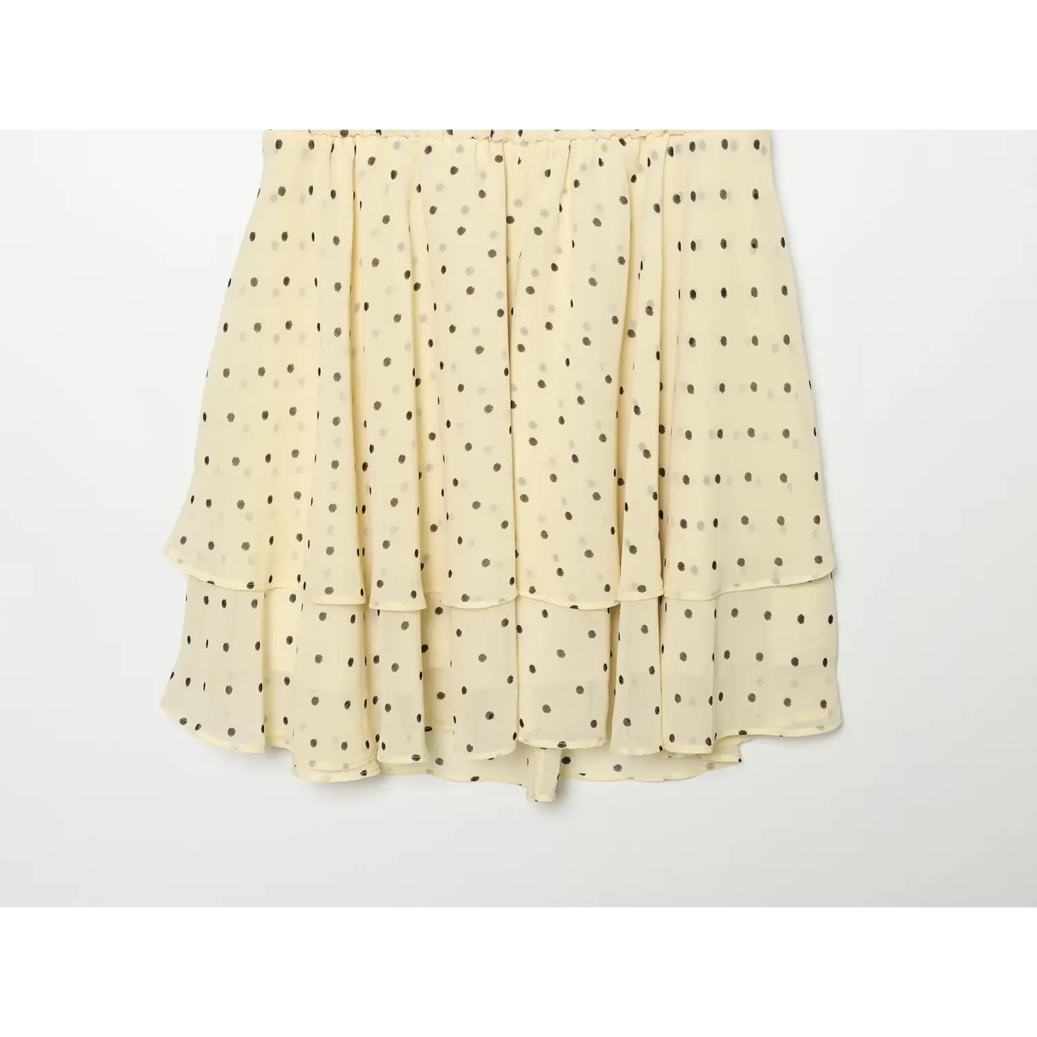 Flat lay shot of elasticated waist and two-layer ruffle chiffon skirt, all-over scattered gray polka dots