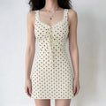 Front lifestyle shot on model, slim fit cream polka dot lace trim mini dress, sweet vintage casual outfit