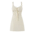 Full front flat lay main shot, cream base black polka dot mini slip dress, lace trim V neck, front lace tie detail, slim fit A-line skirt