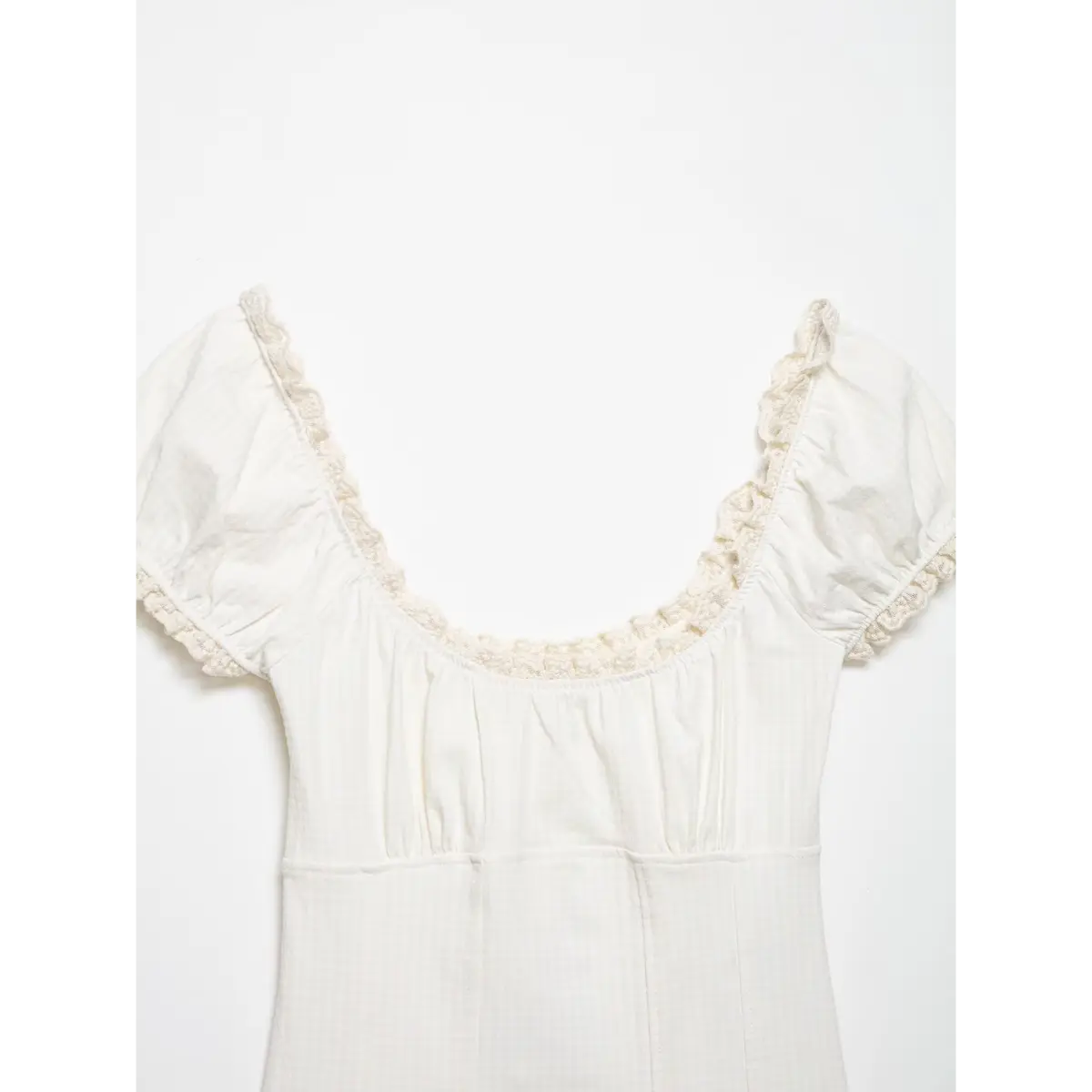  Front view of the top, highlighting the lace-trimmed scoop neck, gathered bust, and corset-style seams.