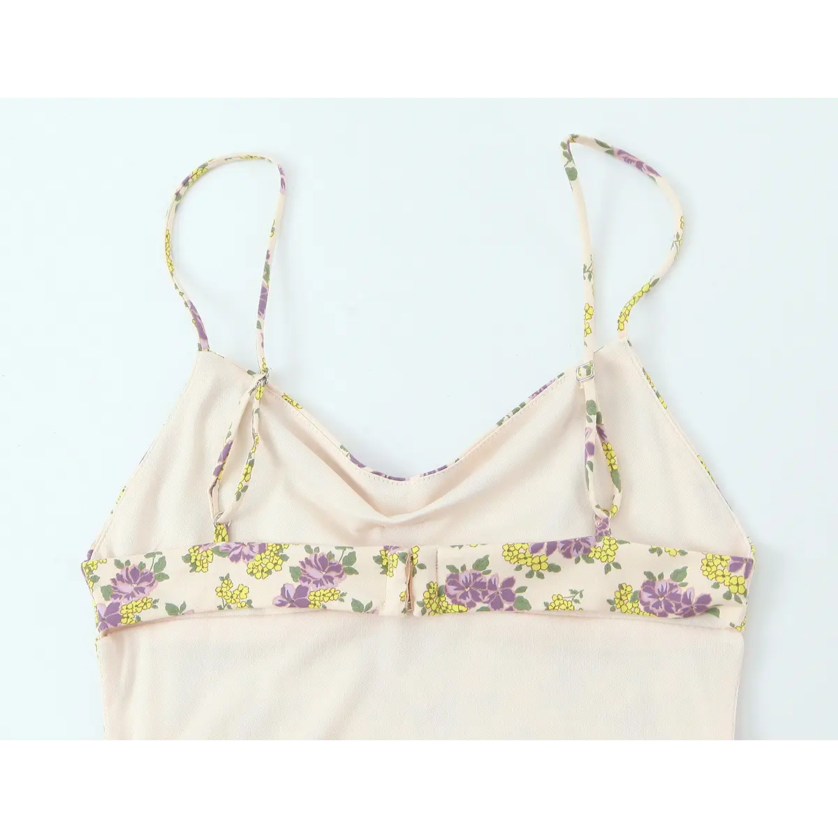 Back view of the cream floral dress, showing the adjustable straps and inner construction