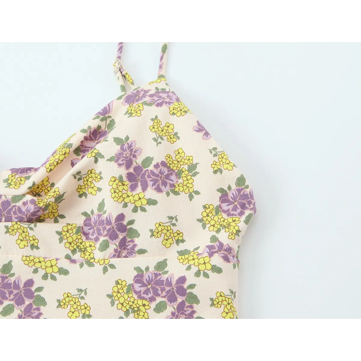 Close-up of the dress bodice, showing the cowl neckline and floral print
