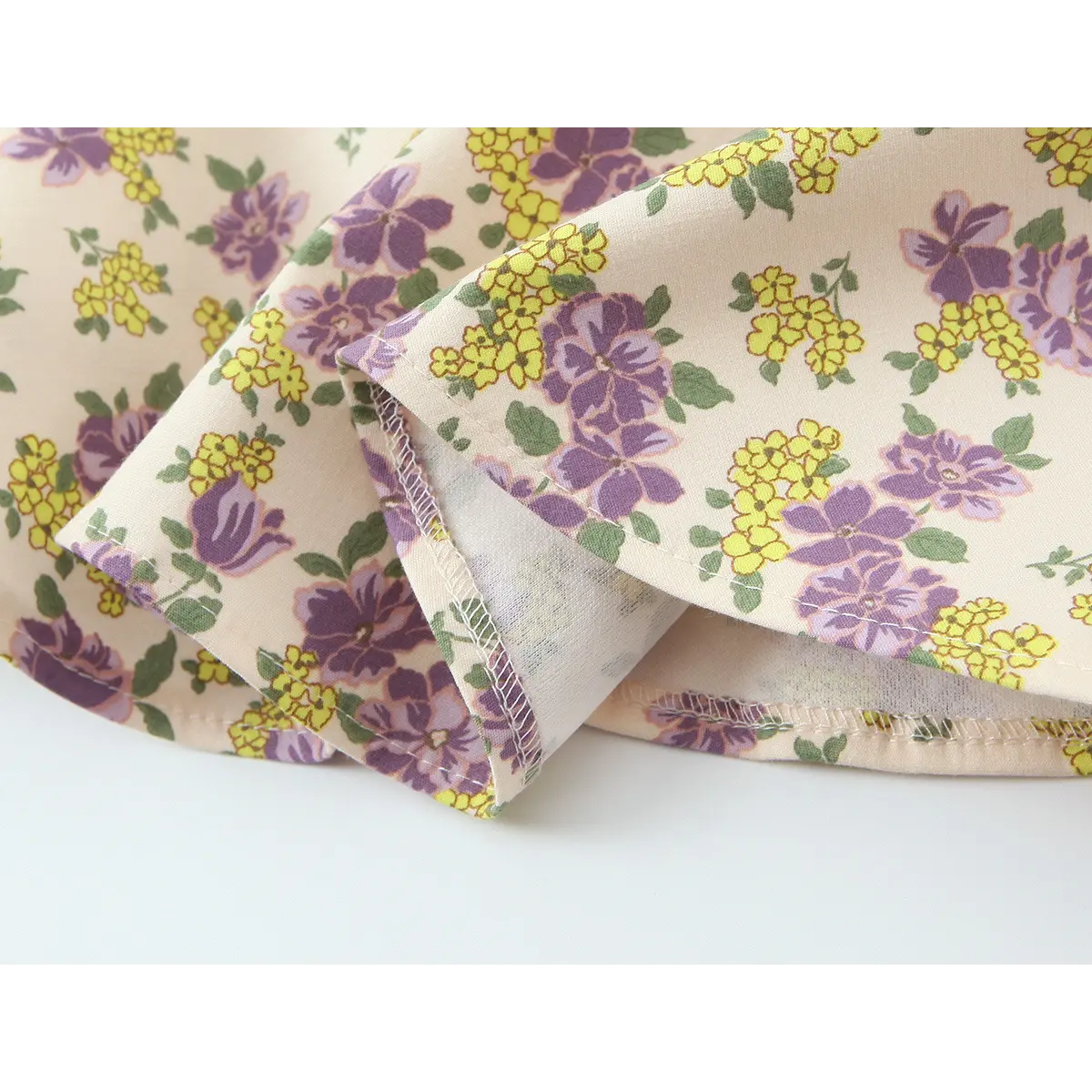 Close-up of the dress seam, showing the stitched hem and soft lining
