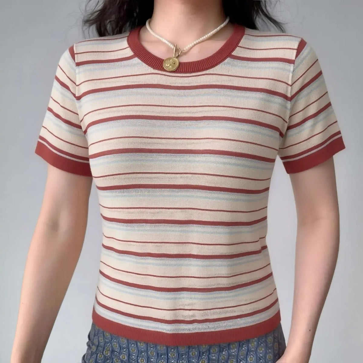 Model wearing cream red light‑blue stripe crew neck short sleeve knit top front view