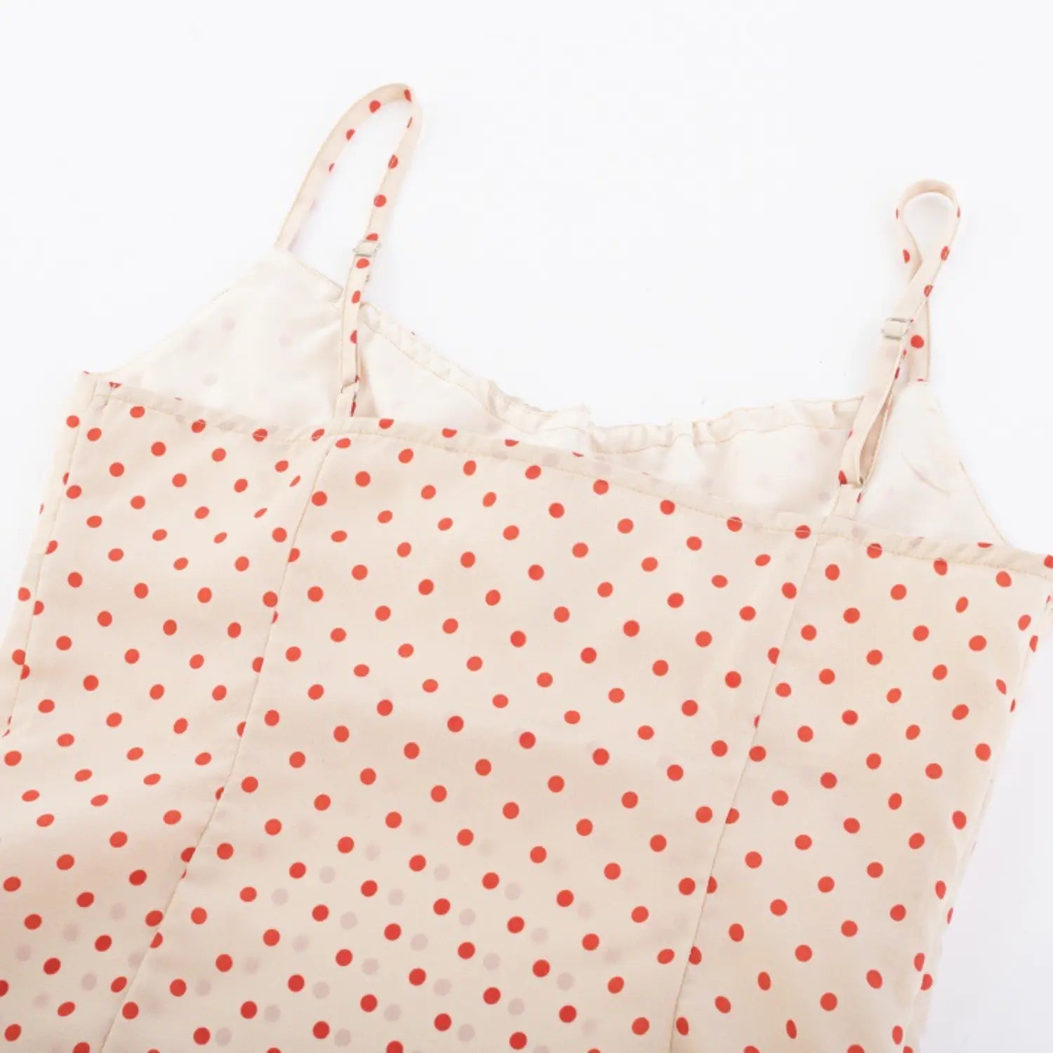 Full back view on white background of cream red polka dot camisole with adjustable straps