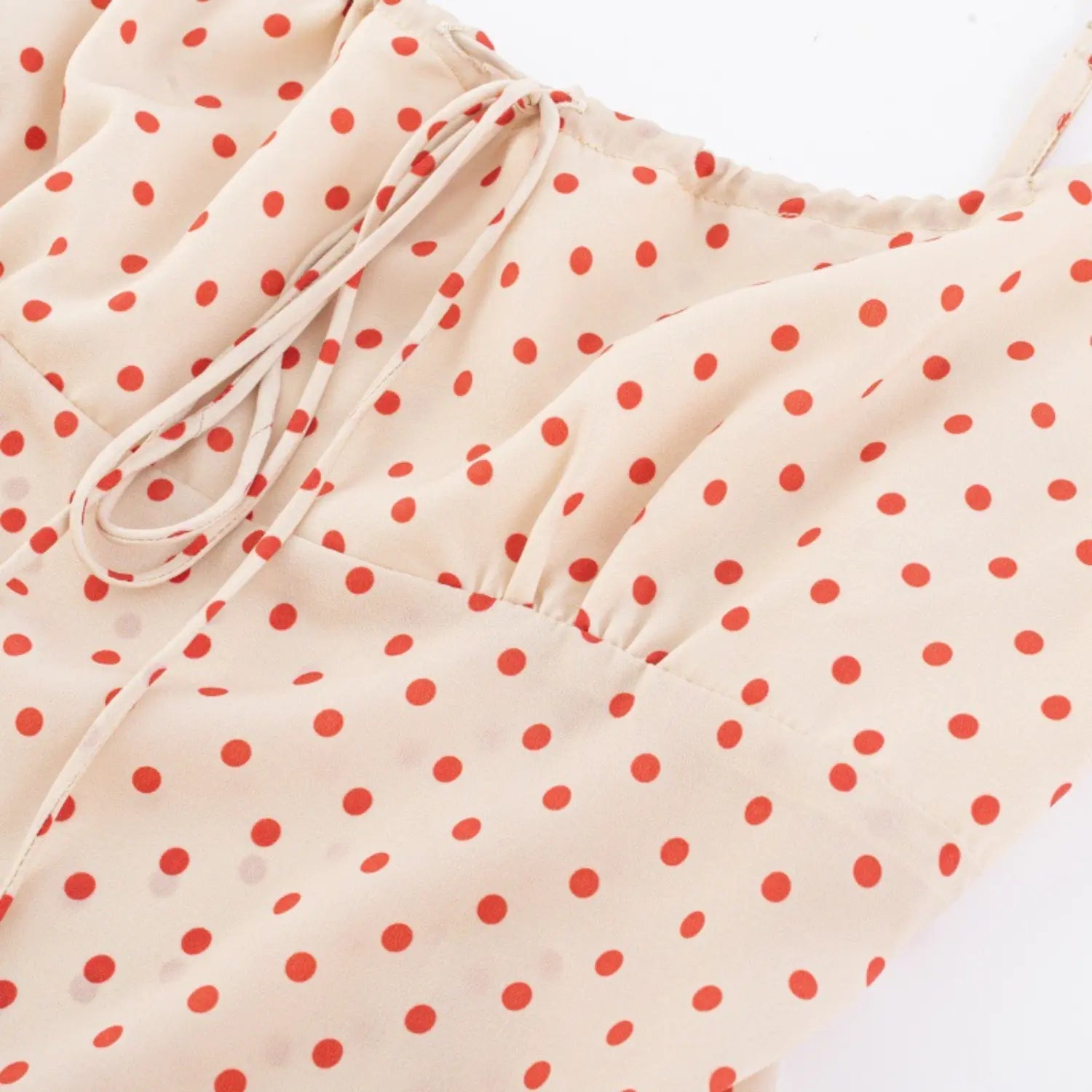 Close-up of the gathered bust detail on cream red polka dot camisole