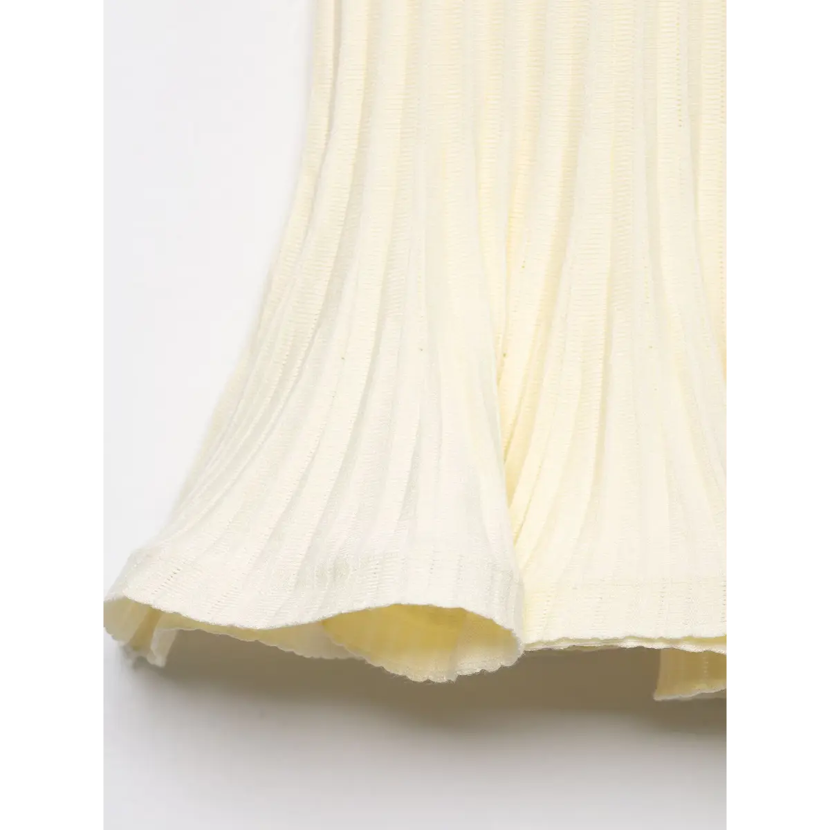 Close-up of the peplum hem, showing the soft knit texture and double-layered ruffled finish