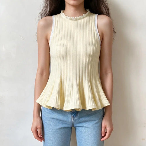Cream ribbed knit tank top with white ruffle trim at neck and armholes, flared peplum hem