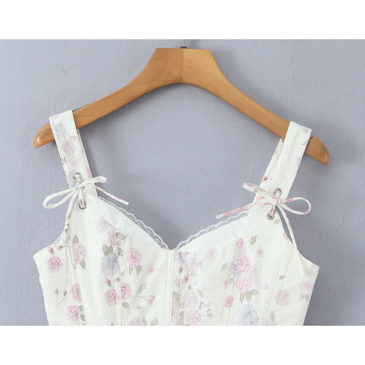 Close-up of sweetheart neckline with lace trim and ribbon-tie adjustable straps.