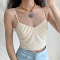 Woman wearing cream ruched v neck crisscross strap camisole crop top casual outfit