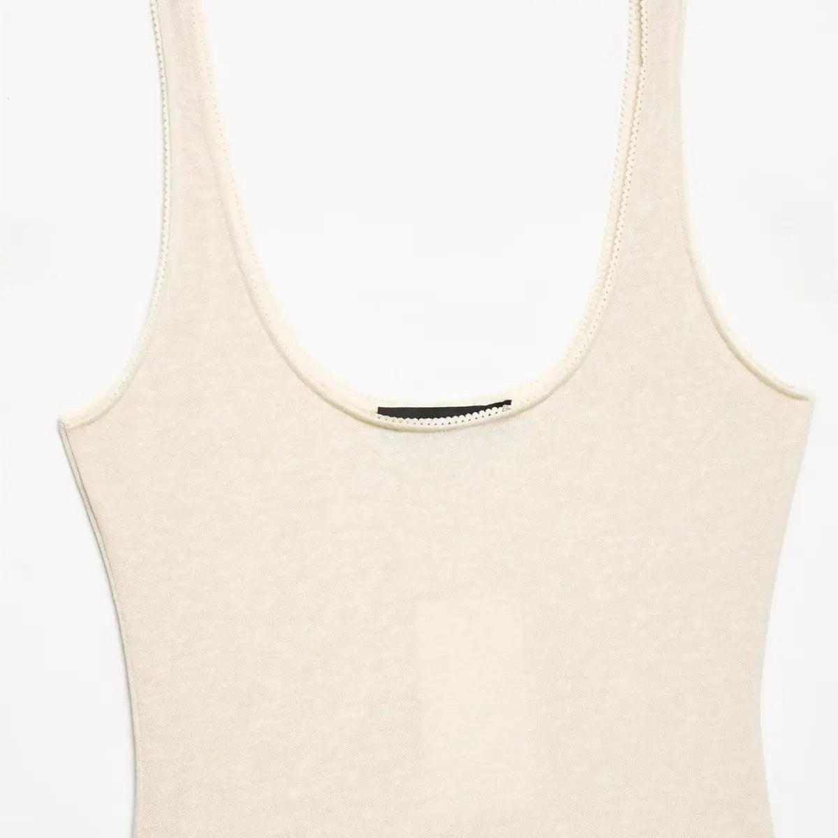 Full view of the knit bodice, showcasing the scoop neckline, scalloped trim, and form-fitting silhouette.