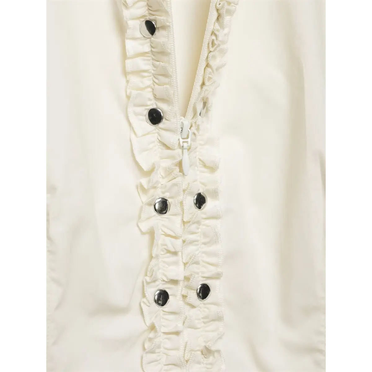 Close-up of the front zipper and ruffled placket, with metal button accents