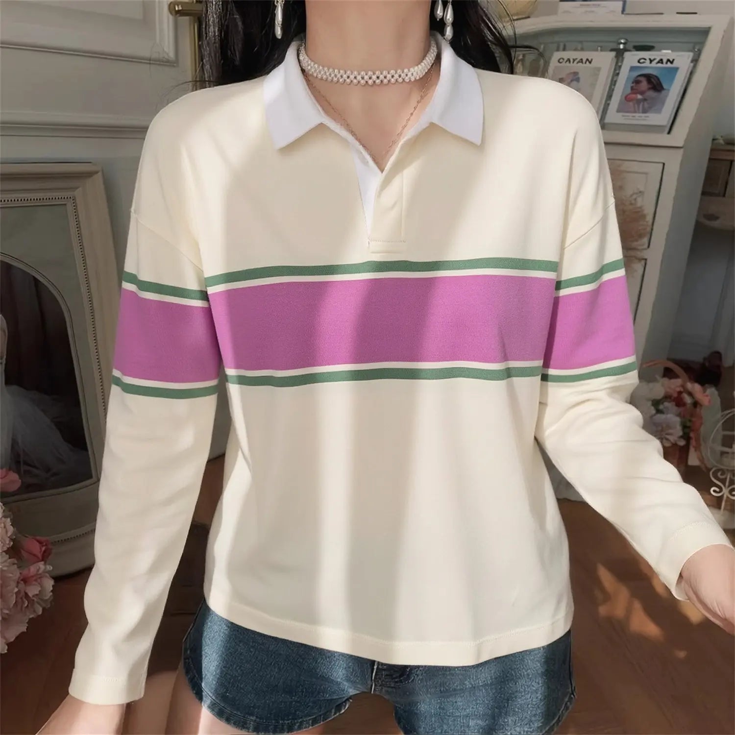 Model front wearing shot cream long sleeve rugby polo shirt white collar pink green horizontal stripe casual everyday outfit