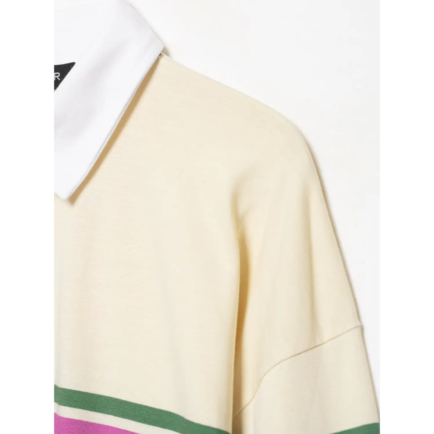Side close‑up shoulder seam and collar edge detail cream color‑block striped long sleeve polo shirt