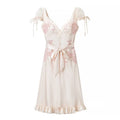 Cream satin midi dress with pink floral embroidery, v-neck, short mesh tie sleeves, waist sash bow and ruffle hem, front view