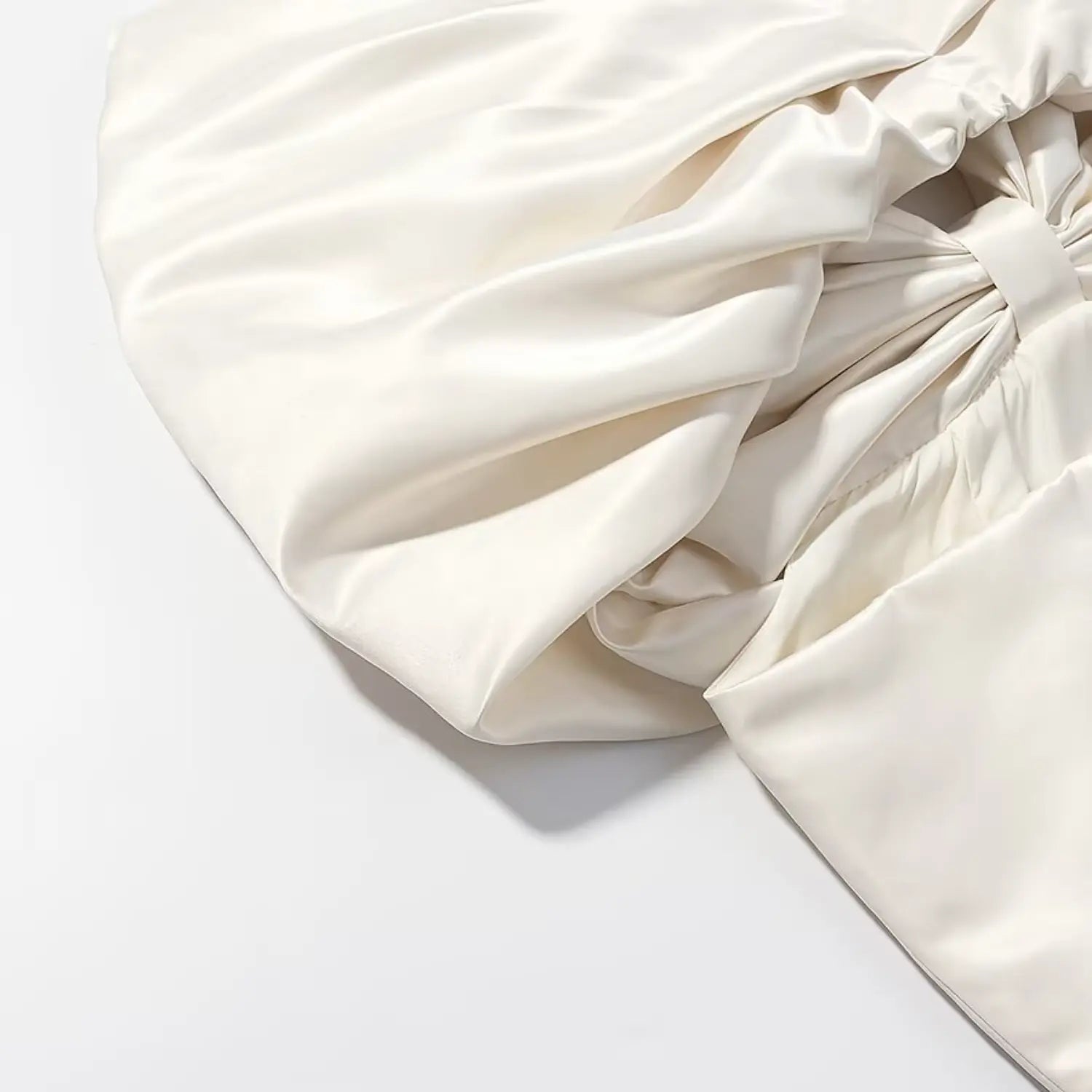 Folded glossy satin texture close-up of large decorative bow