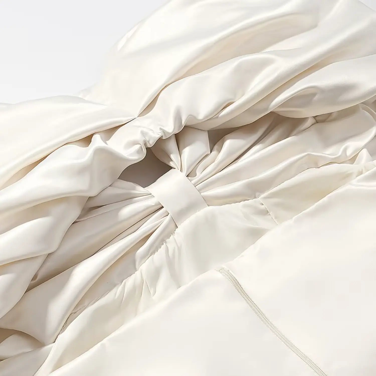 Inner stitching and gathering detail of oversized satin bow