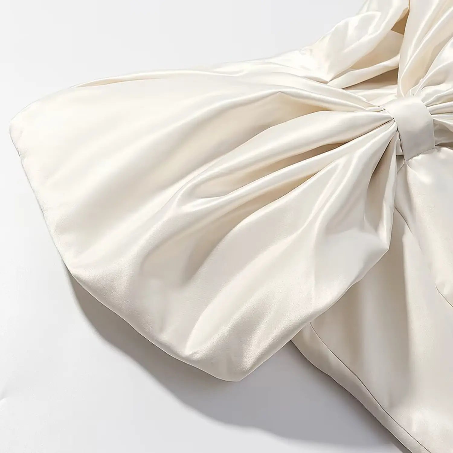 Side fabric texture close-up of oversized satin bow detail