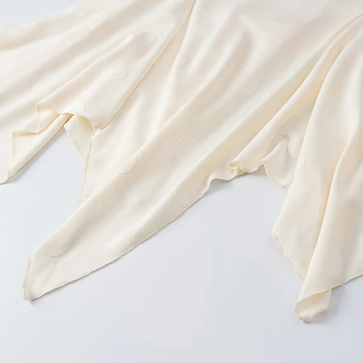 Close-up of handkerchief ruffle hem detail