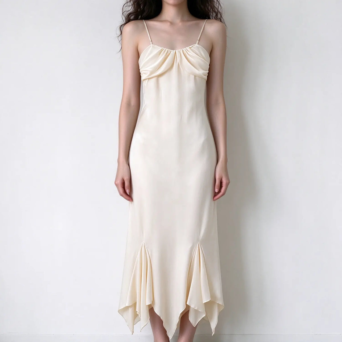 Model wearing cream satin ruched cami midi dress, front view