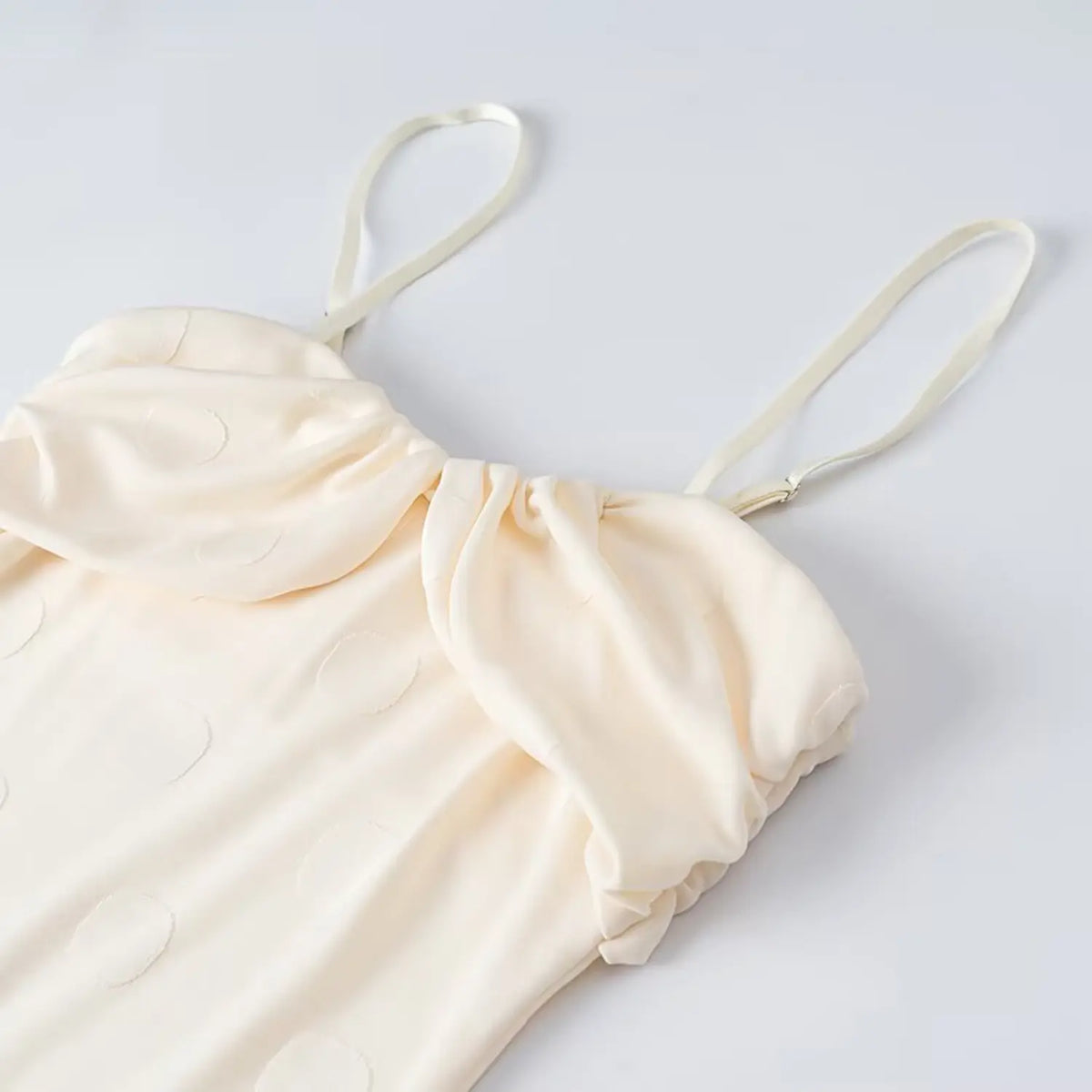 Close-up of ruched neckline and cami straps