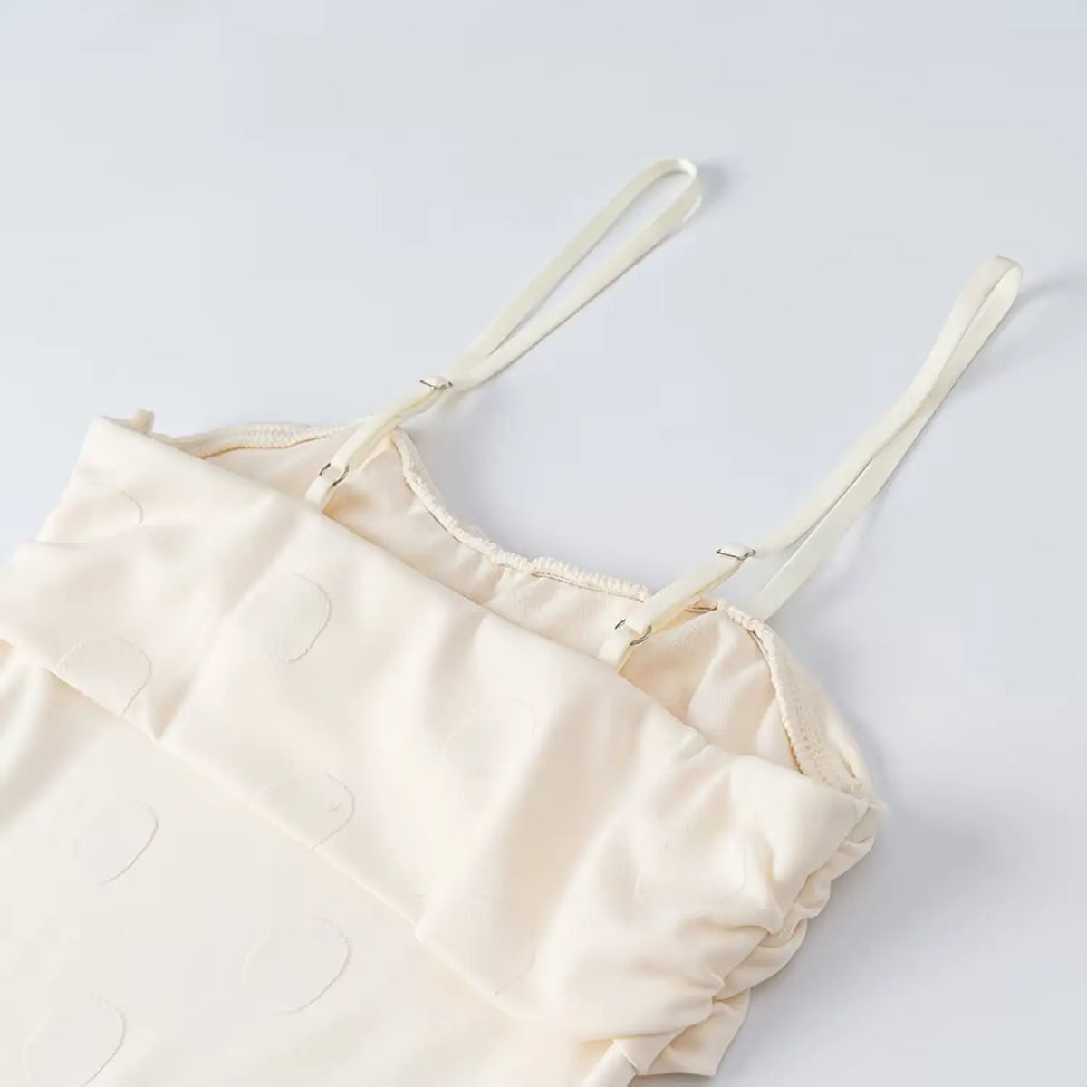 Close-up of adjustable cami straps and lining