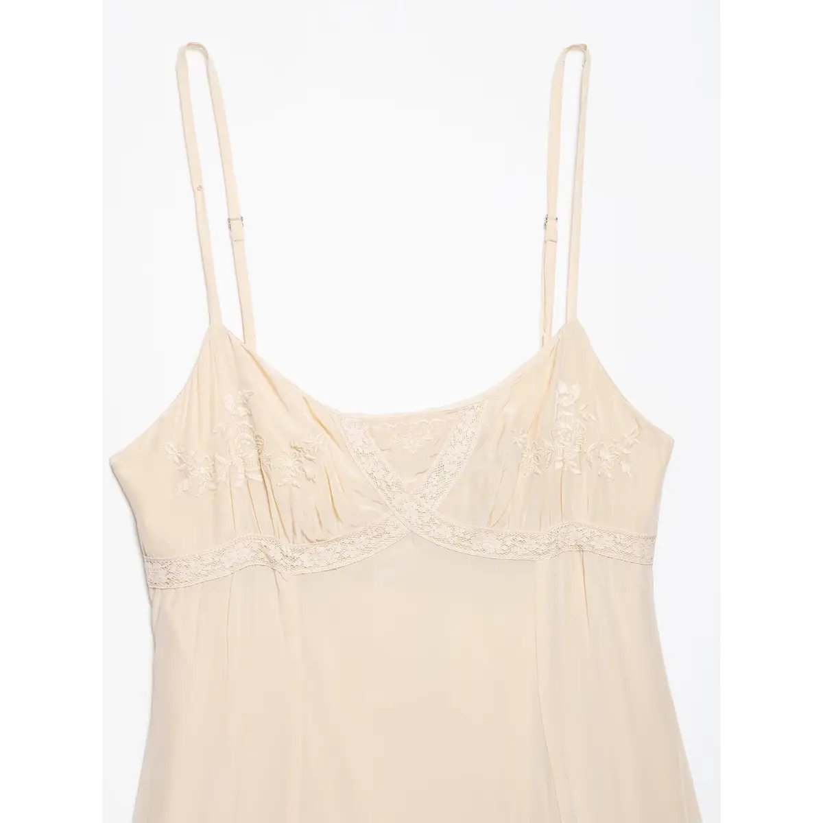 Close-up of the dress's front neckline, showcasing the crisscross lace design and gathered fabric.