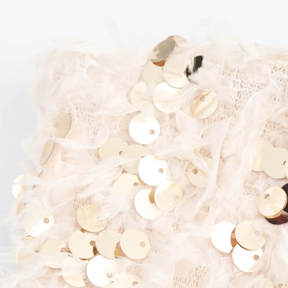 Wide detail shot of the all-over feather and sequin pattern on the cream bandeau top.