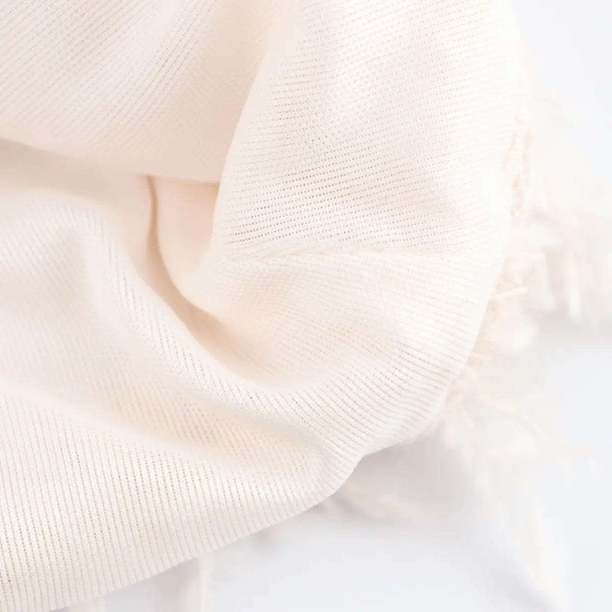 Close-up of the soft, stretch knit lining inside the cream sequin bandeau top.