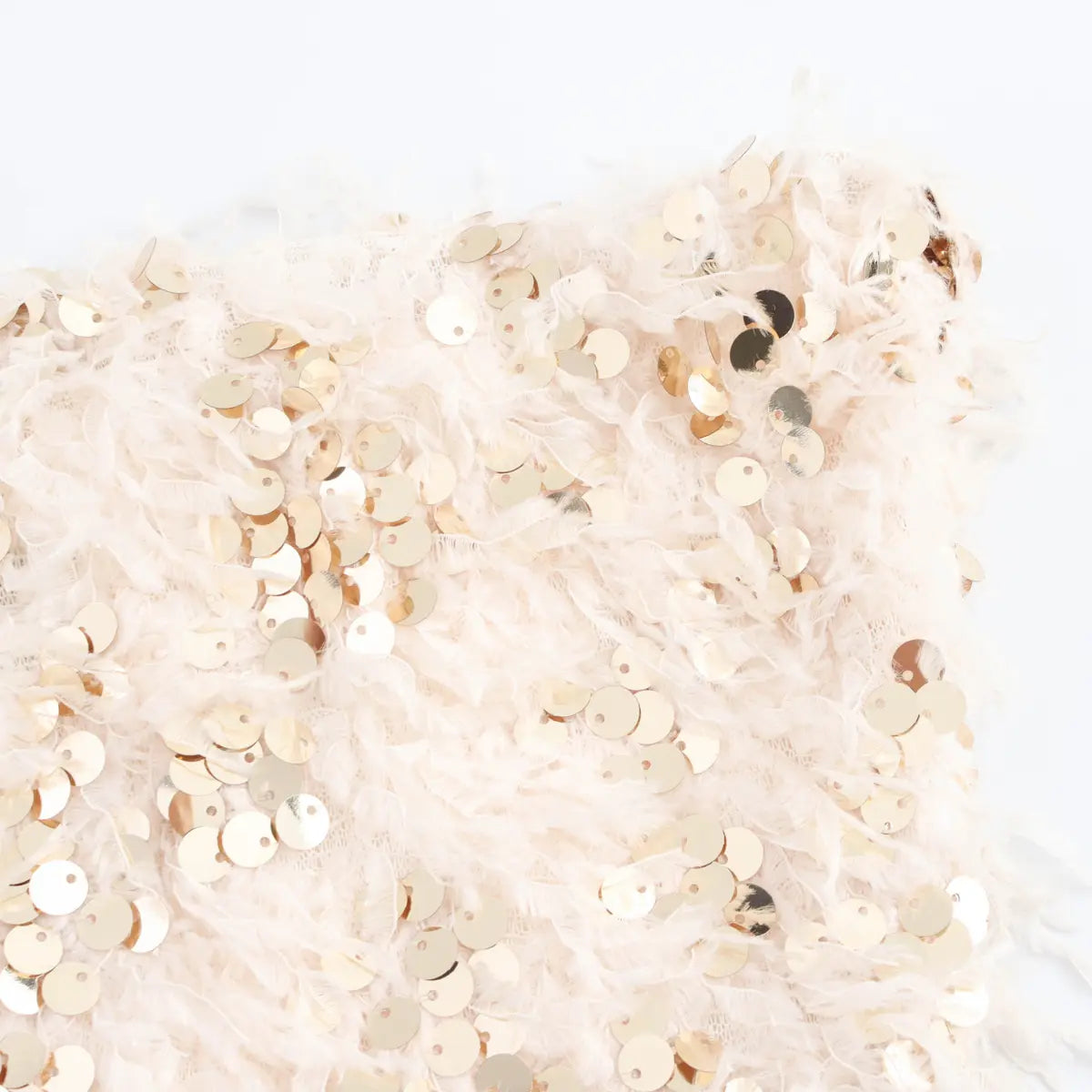 Close-up detail of the reflective gold sequins on the cream feather bandeau top.