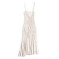 Full view of the cream spaghetti-strap mermaid maxi dress, featuring diagonal drawstring ruching and a flared hem