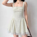 Lifestyle shot of offwhite tweed mini dress with front bow, lace hem and fitted waist.