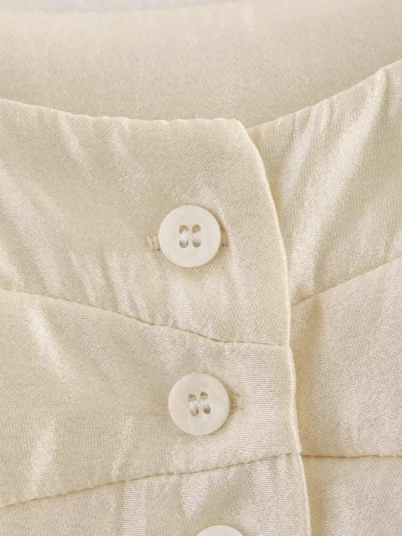 Macro close-up of ivory button and woven fabric