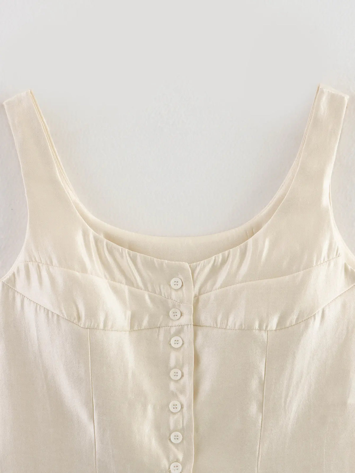 Close-up of square neckline and button placket