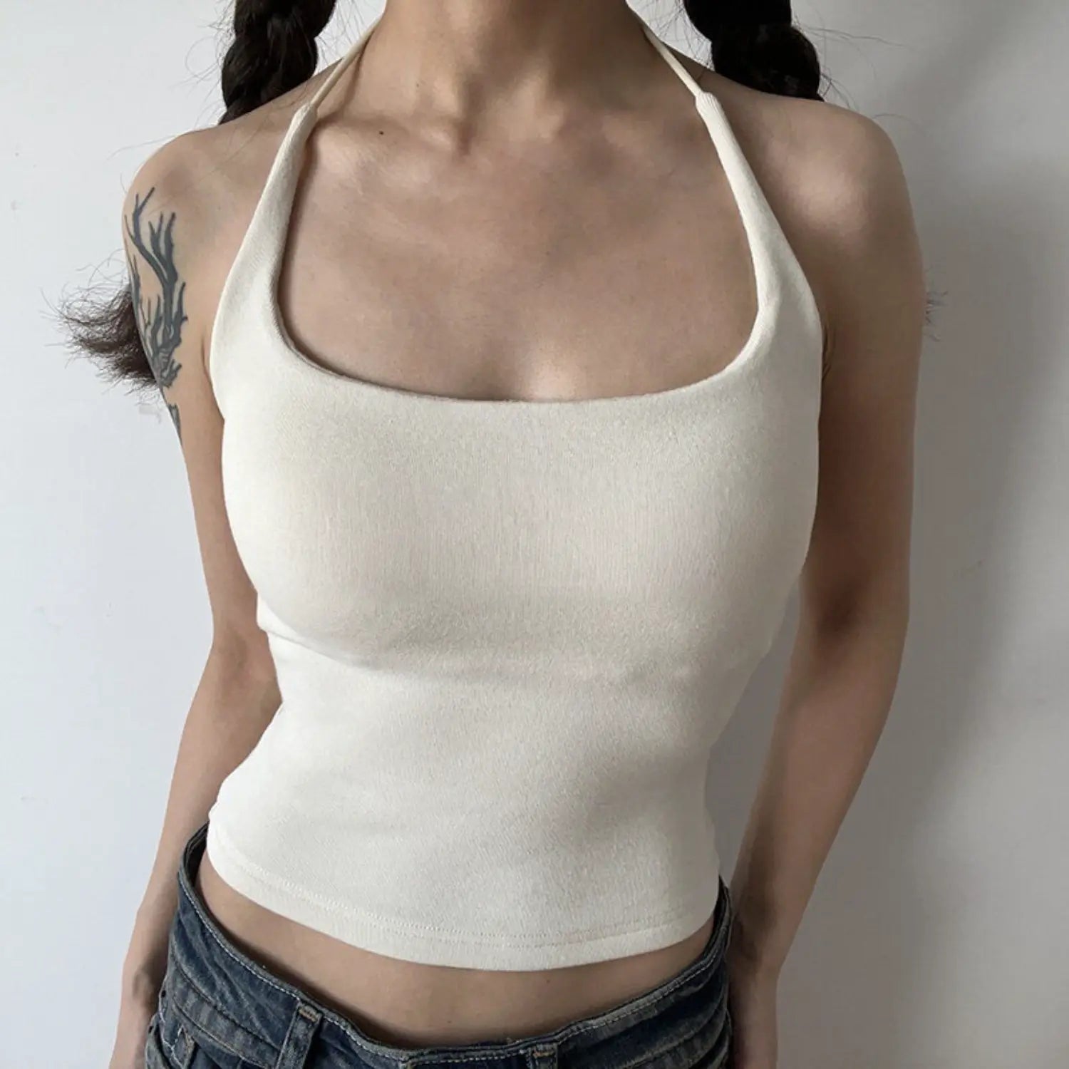 Cream square neck halter knit cami half body indoor model shot, U wide square neck thin halter tie waist cinched cropped fit matched with denim daily feminine outfit display